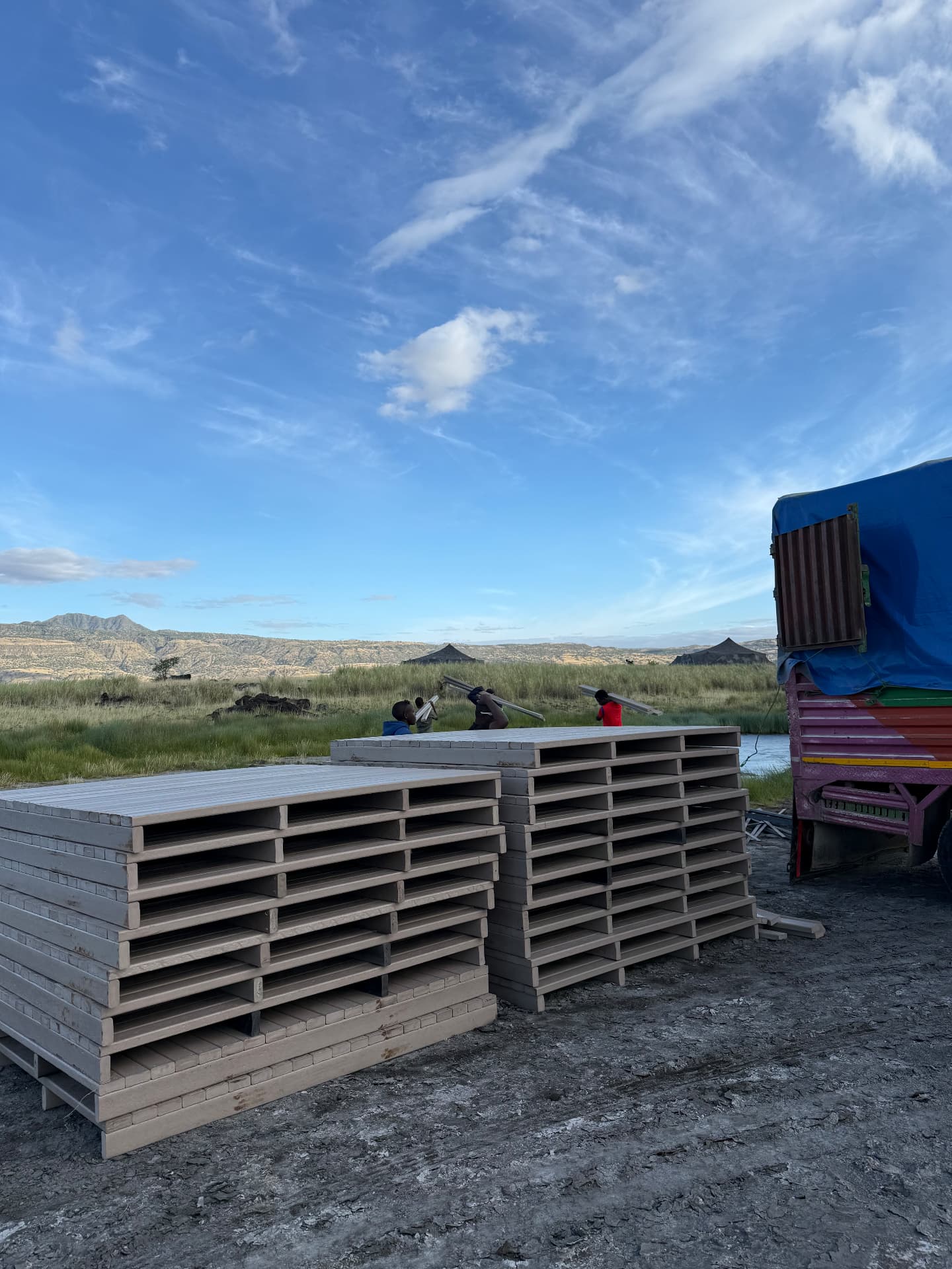 Prefabricated recycled plastic deck platforms stacked for site delivery