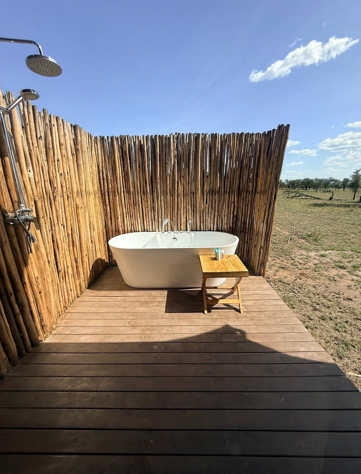 Recycled plastic decking laid in an outdoor bathroom with a freestanding bathtub and safari views