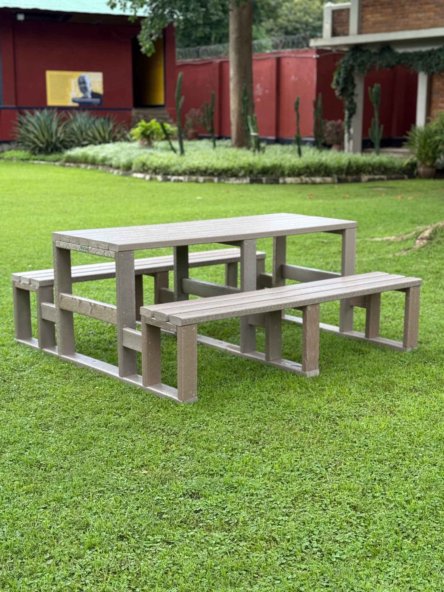 Recycled plastic picnic table with benches in a courtyard