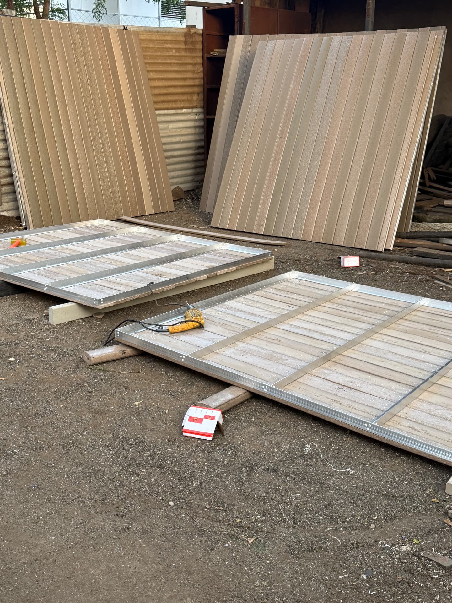 Prefabricated recycled plastic wall and floor panels on aluminium frames being assembled for Nyikani Camps