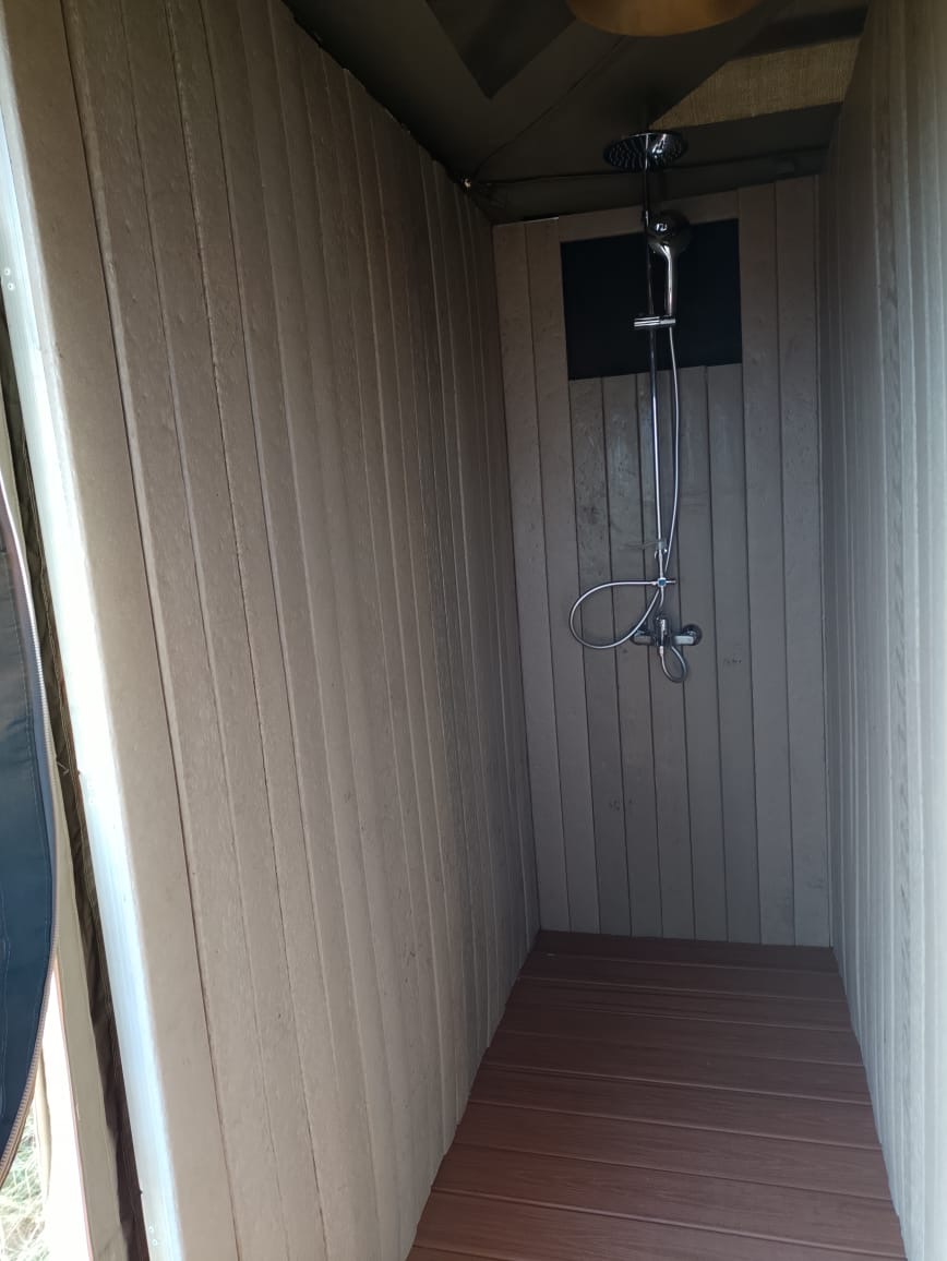 Recycled plastic cladding lining a safari camp shower room