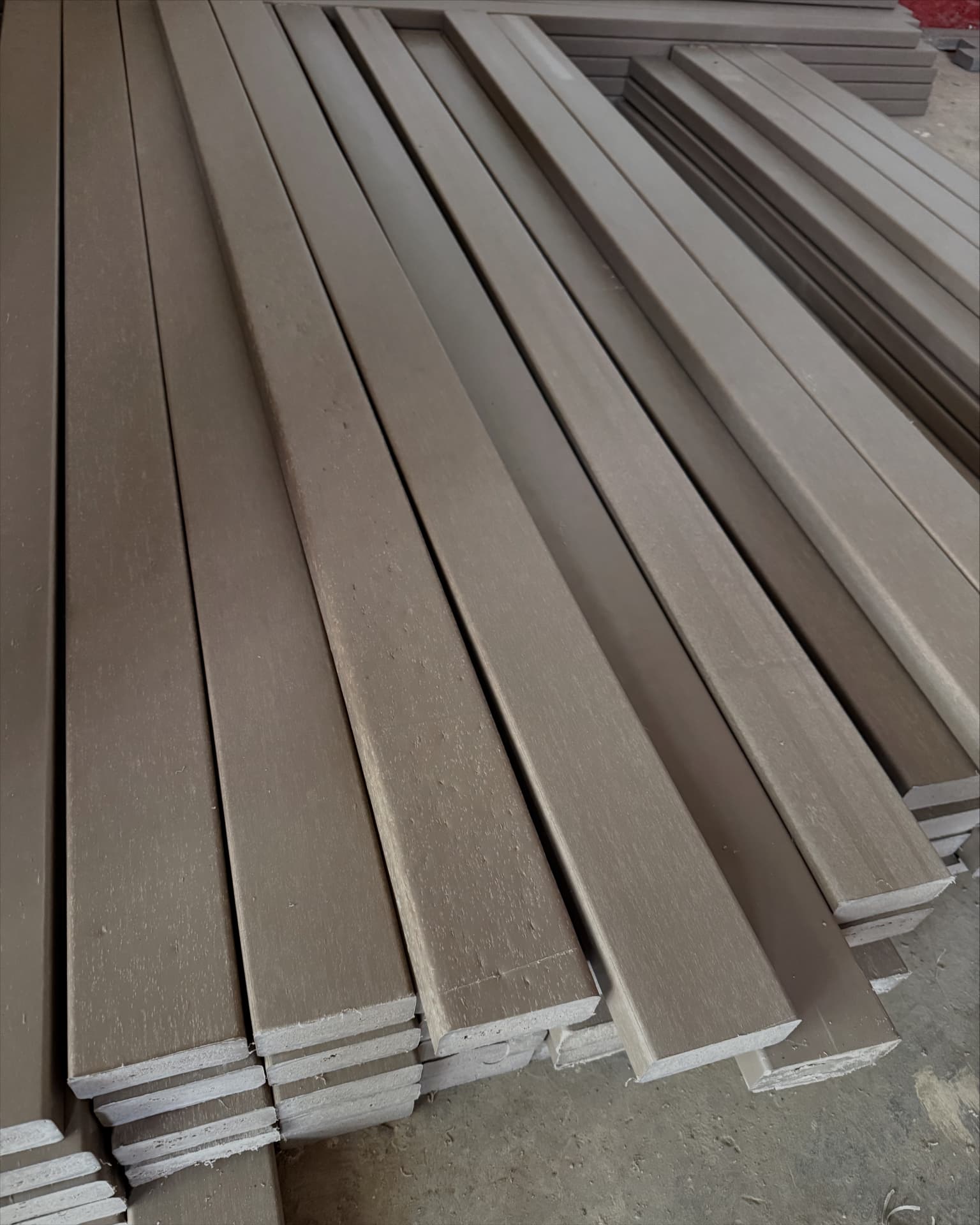 Stacked solid recycled plastic construction lumber in the Green Venture factory