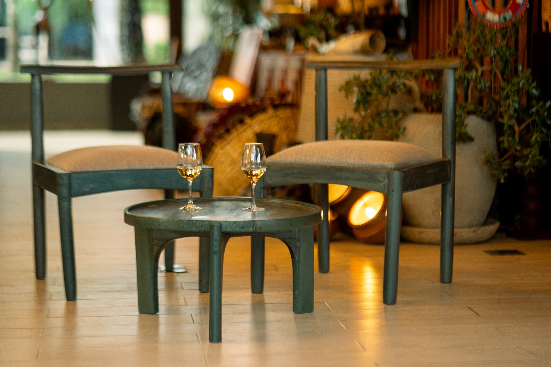 Premium recycled plastic chairs and side table in a warm interior lounge setting