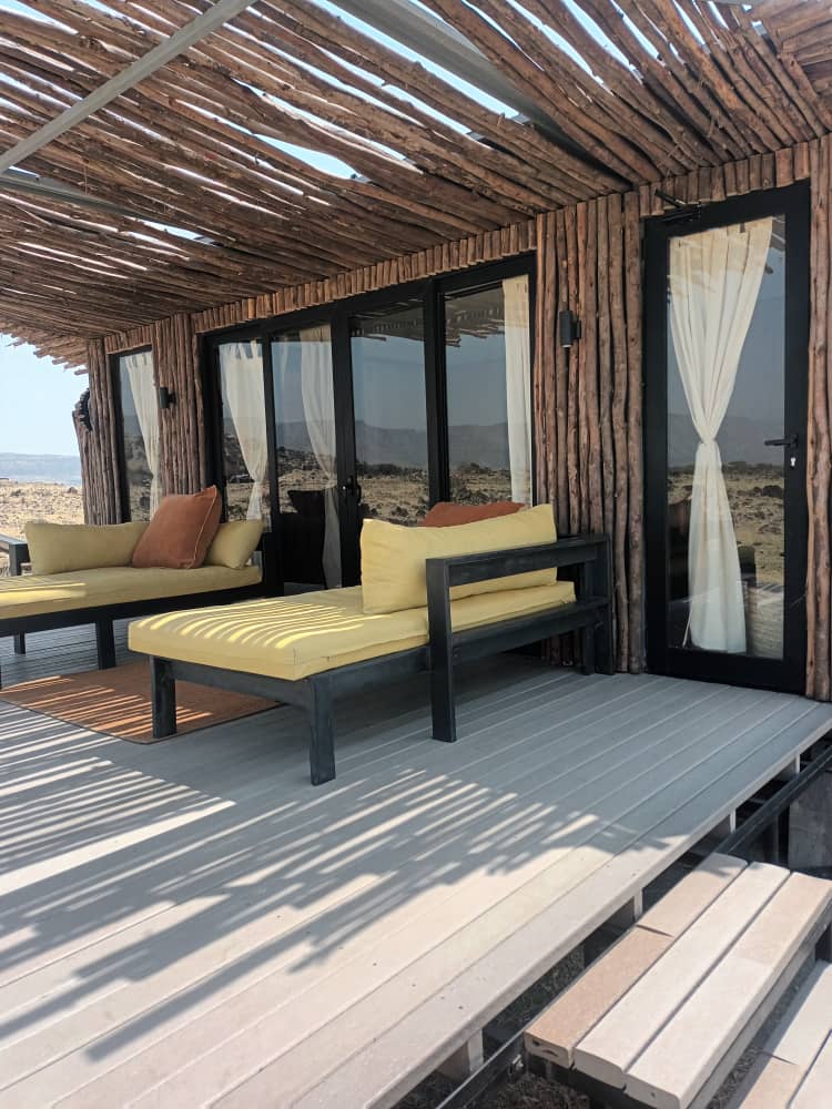 Shaded lounge terrace on recycled plastic decking outside a guest suite at Leonotis Adventures, Lake Natron