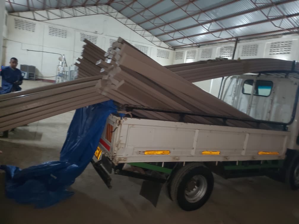 Recycled plastic lumber profiles being loaded onto a delivery truck at the Green Venture factory in Arusha