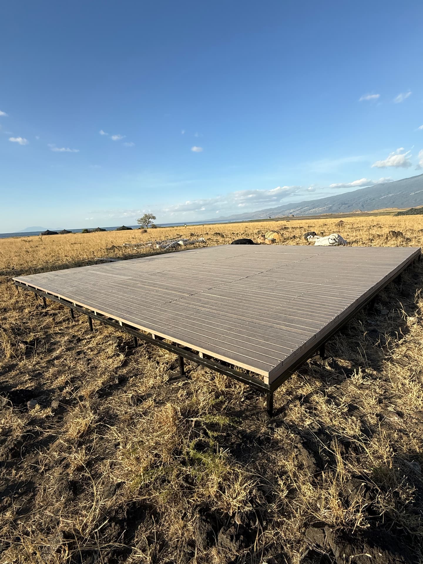 Large recycled plastic deck platform on a steel frame overlooking Lake Natron