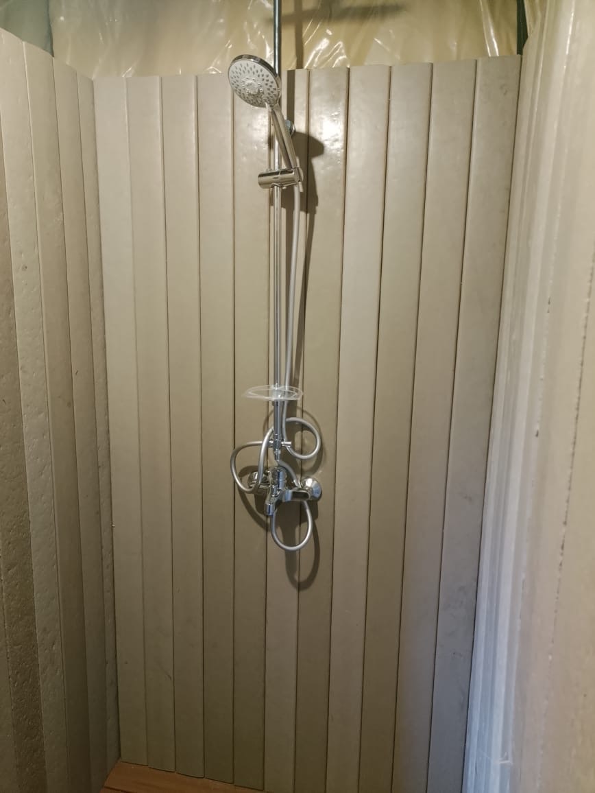 Recycled plastic clad shower enclosure inside a Nyikani tented suite