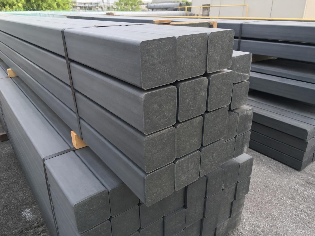 Stacked recycled plastic structural posts and beams in a yard